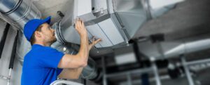 HVAC repair technician repairing a commercial duct system